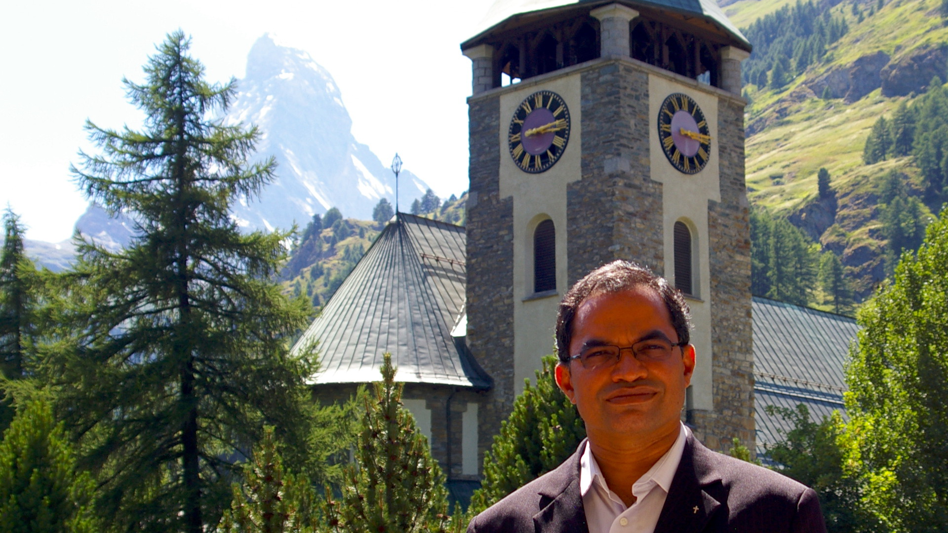 Vikar Albert Noronha vor dem Matterhorn und der Dorfkirche Zermatt
