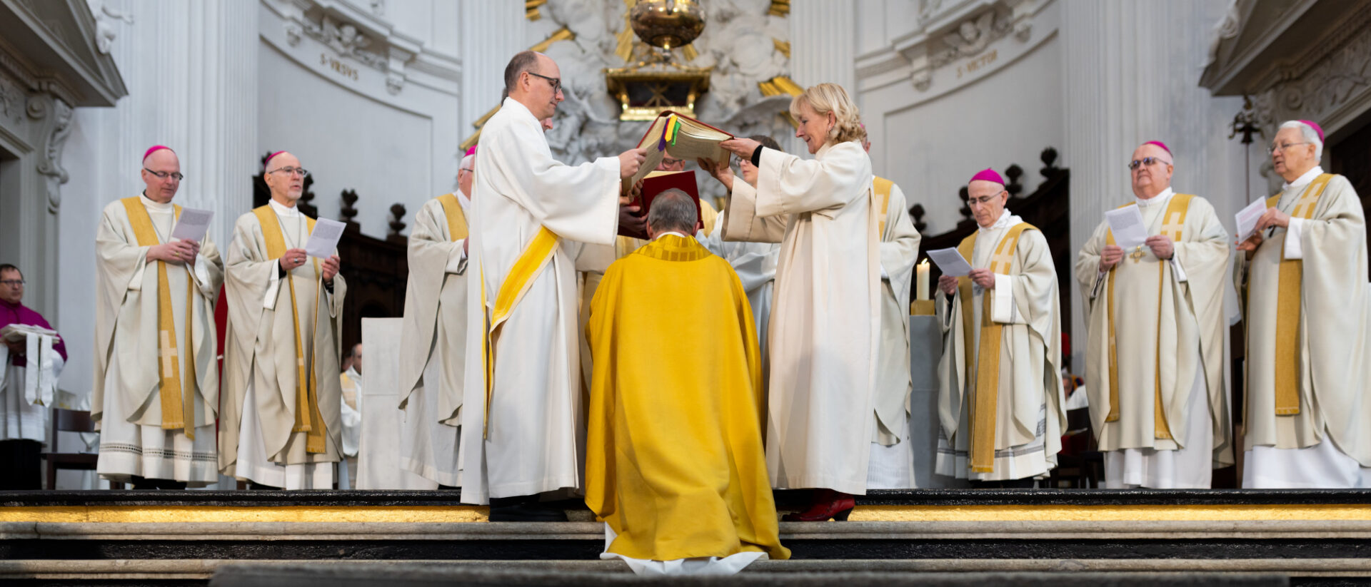 Ella Gremme und David Rüegsegger halten das Evangelienbuch – "wie ein schützendes Dach", sagt später Weihbischof Josef Stübi.