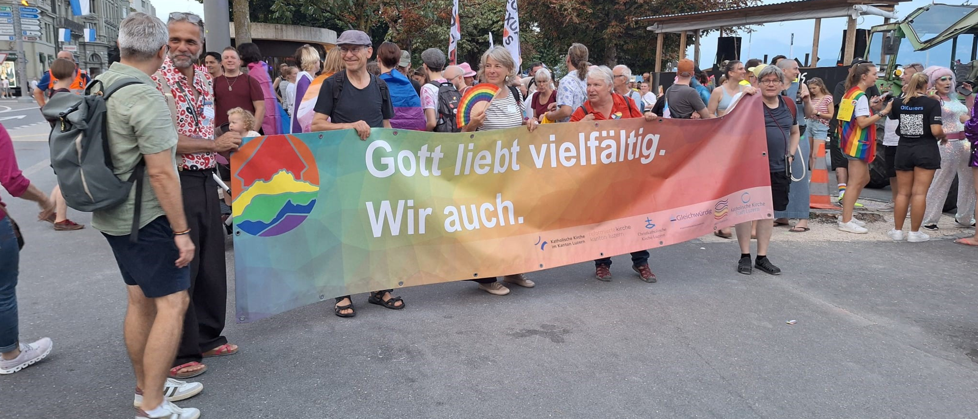 Kirche mit Banner präsent an der Pride-Demo, links Meinrad Furrer